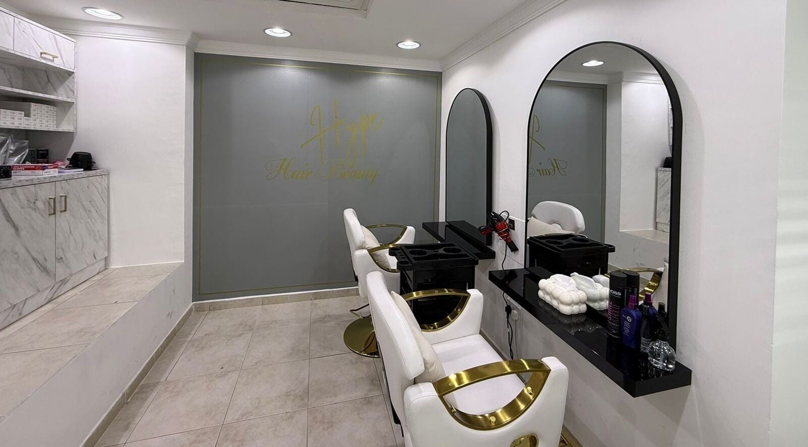 Modern minimalist interior of Hype Nails Beauty Salon in Abu Dhabi, Abu Dhabi, AE, featuring sleek salon chairs.