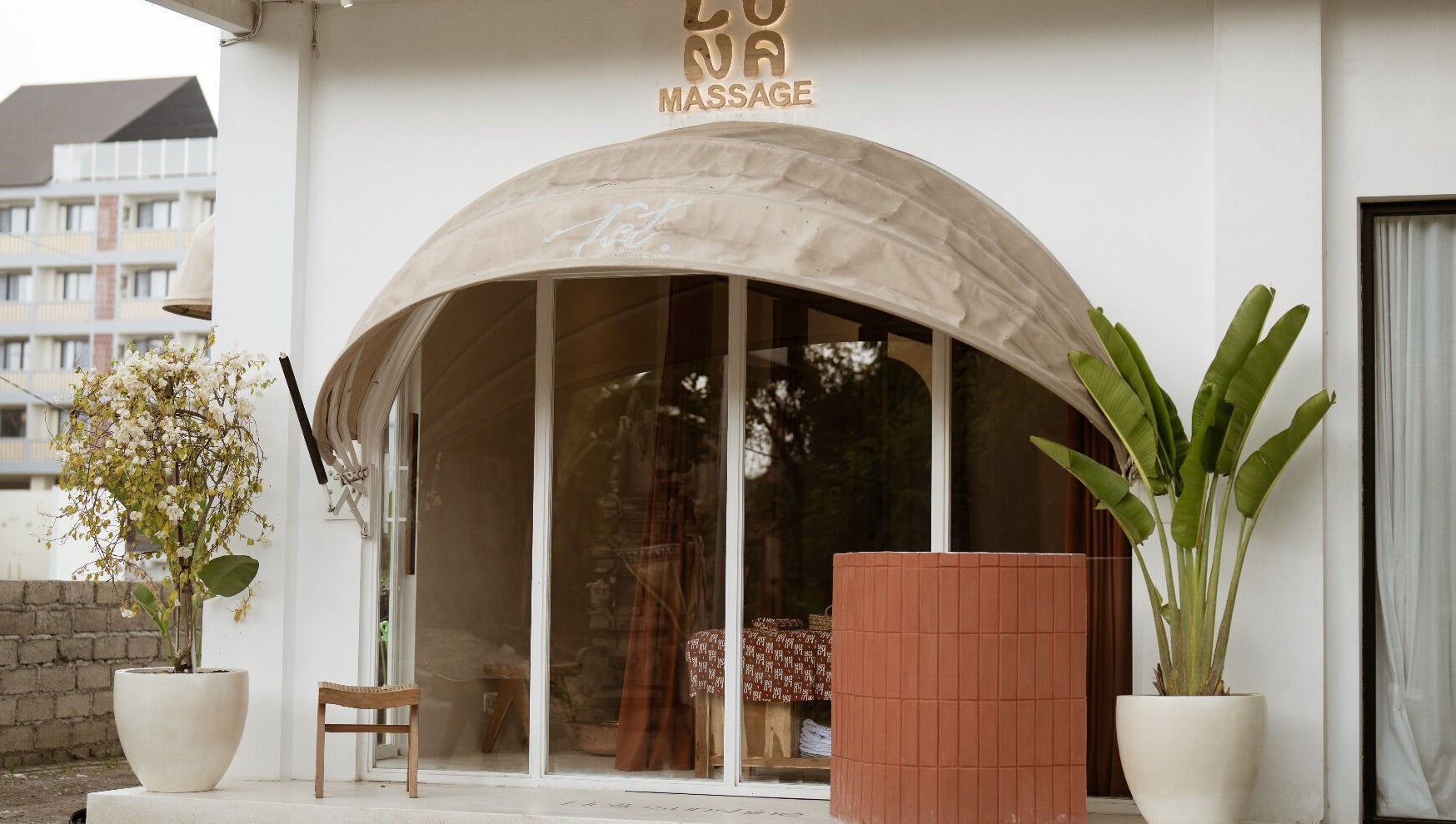 Elegant entrance of Luna massage bali - Pererenan, Bali, ID, featuring potted plants and a welcoming awning.