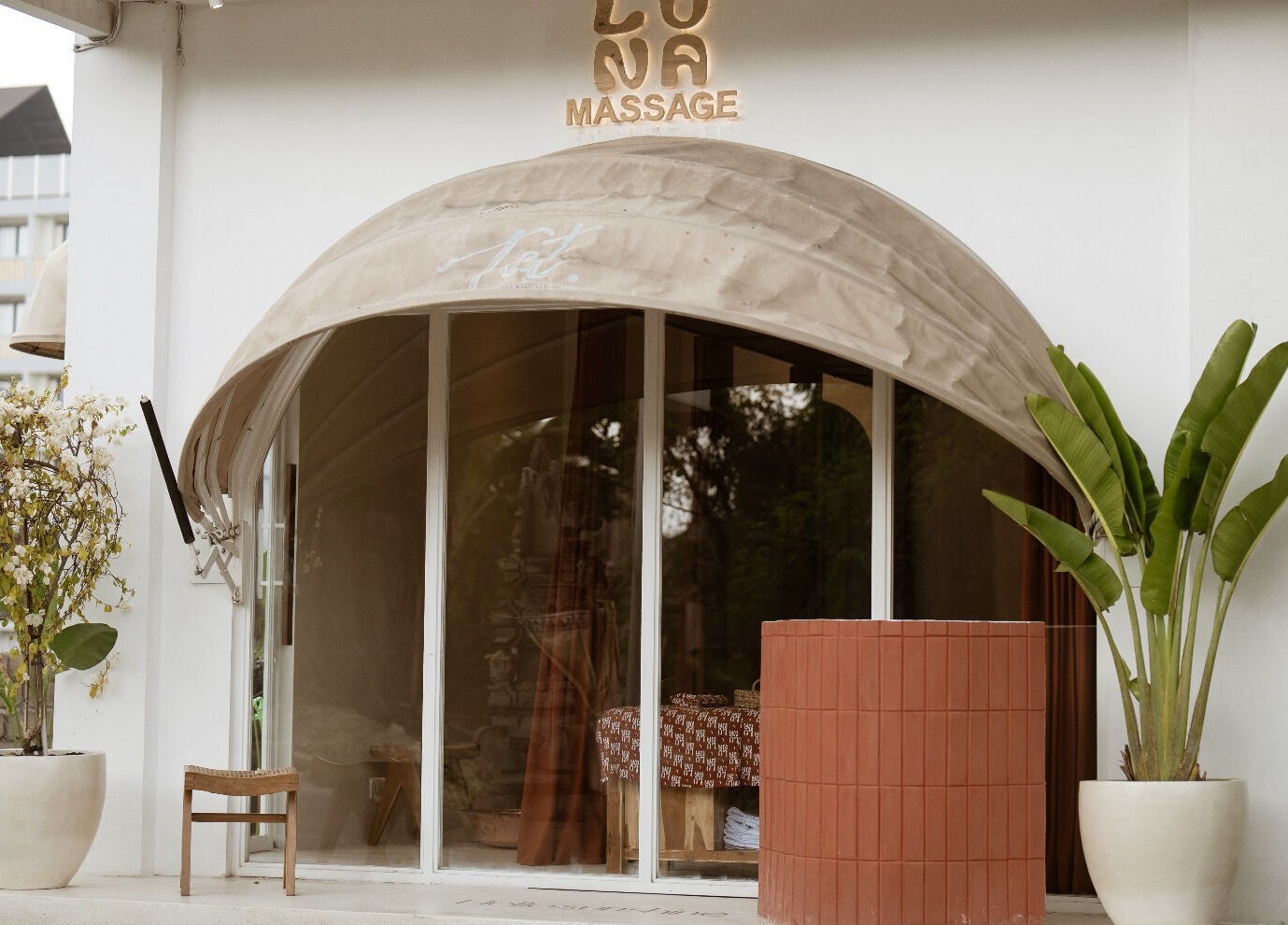 Elegant entrance of Luna massage bali - Pererenan, Bali, ID, featuring potted plants and a welcoming awning.