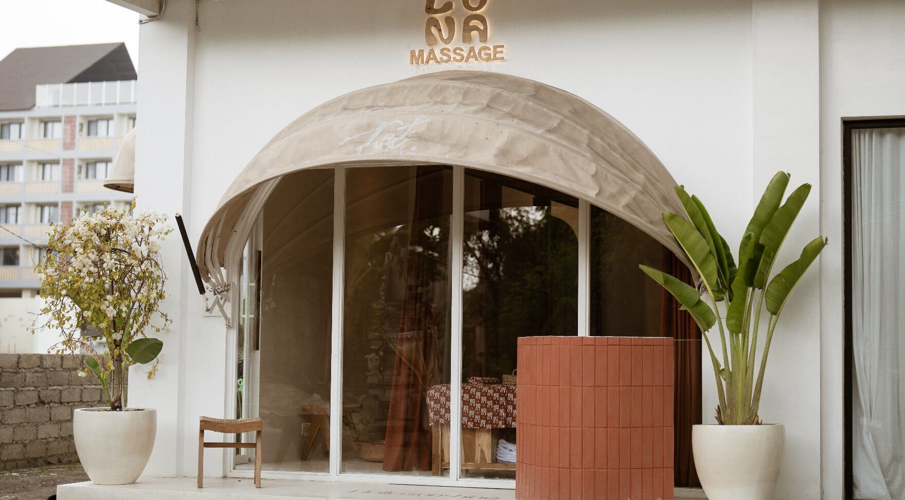 Elegant entrance of Luna massage bali - Pererenan, Bali, ID, featuring potted plants and a welcoming awning.