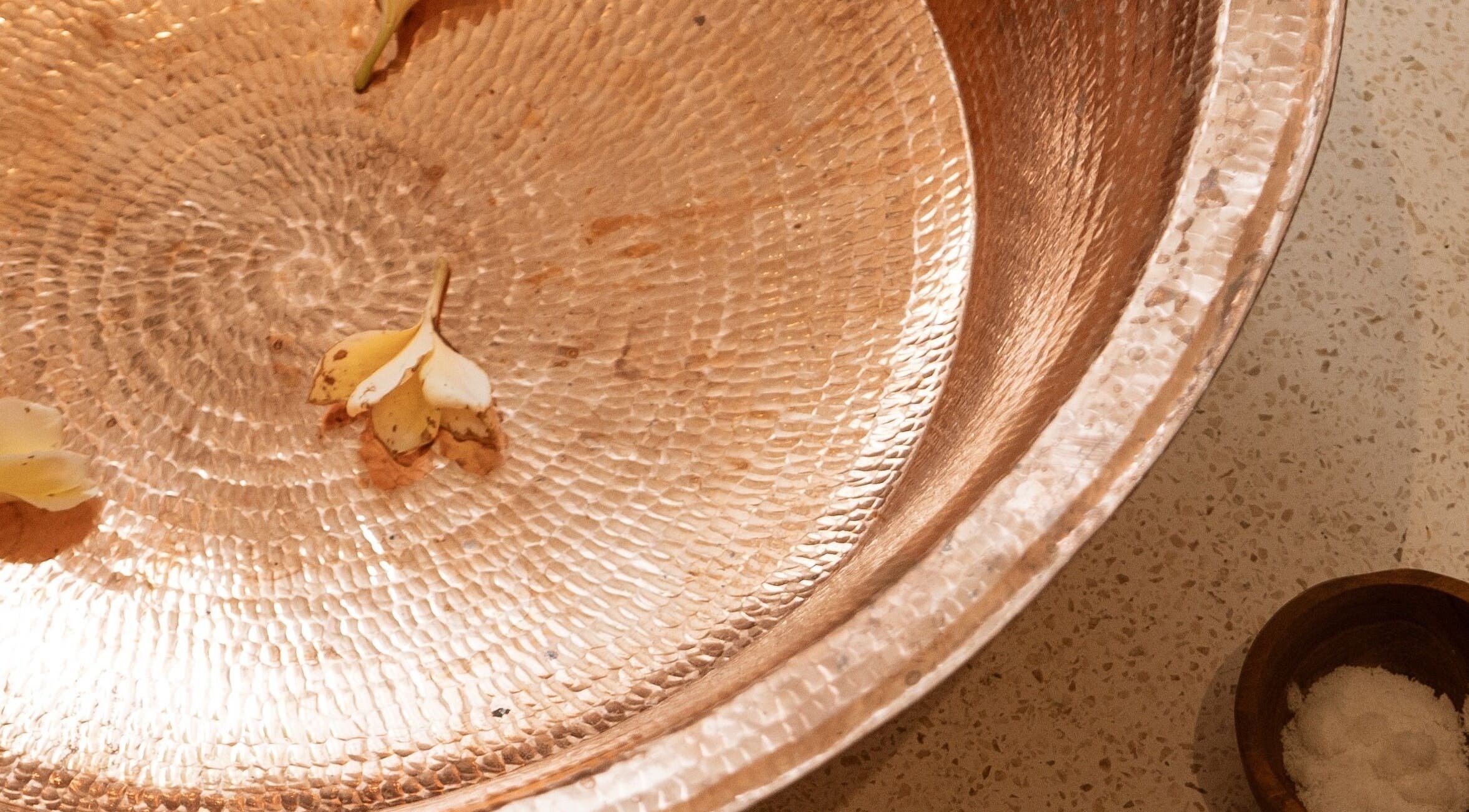 Intricate copper bowl with petals at Luna massage bali - Pererenan, Bali, Bali, ID, showcasing spa tranquility.