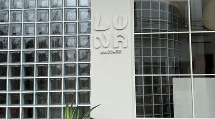 Front view of Luna Massage Seseh entrance in Bali, Bali, ID with glass block wall and logo.
