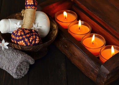 Relaxing spa ambiance at Vedhavillage Spa Trivandrum, Kulathoor, Kerala, IN with candles and herbal balms.