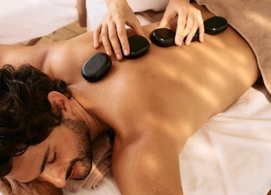 Hot stone massage at Vedhavillage Spa Trivandrum in Kulathoor, Kerala, IN, offering relaxation and wellness.
