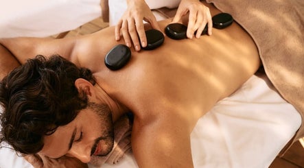 Hot stone massage at Vedhavillage Spa Trivandrum in Kulathoor, Kerala, IN, offering relaxation and wellness.