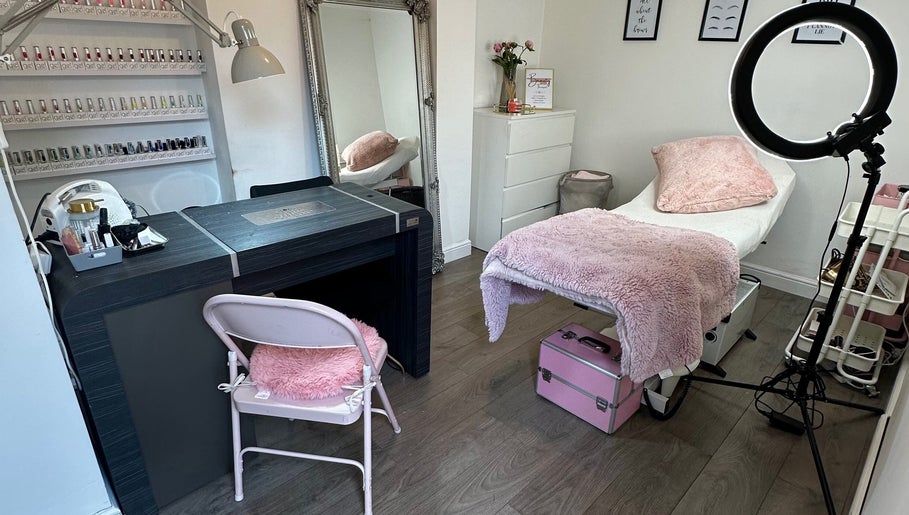Cozy beauty treatment room at Sinéad H Beauty, Great Oakley, England, GB, with plush pink accents.