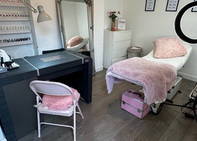 Cozy beauty treatment room at Sinéad H Beauty, Great Oakley, England, GB, with plush pink accents.