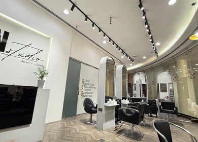 Chic interior of N - Studio Beauty Lounge, Dubai, AE, featuring modern styling chairs and mirrors.