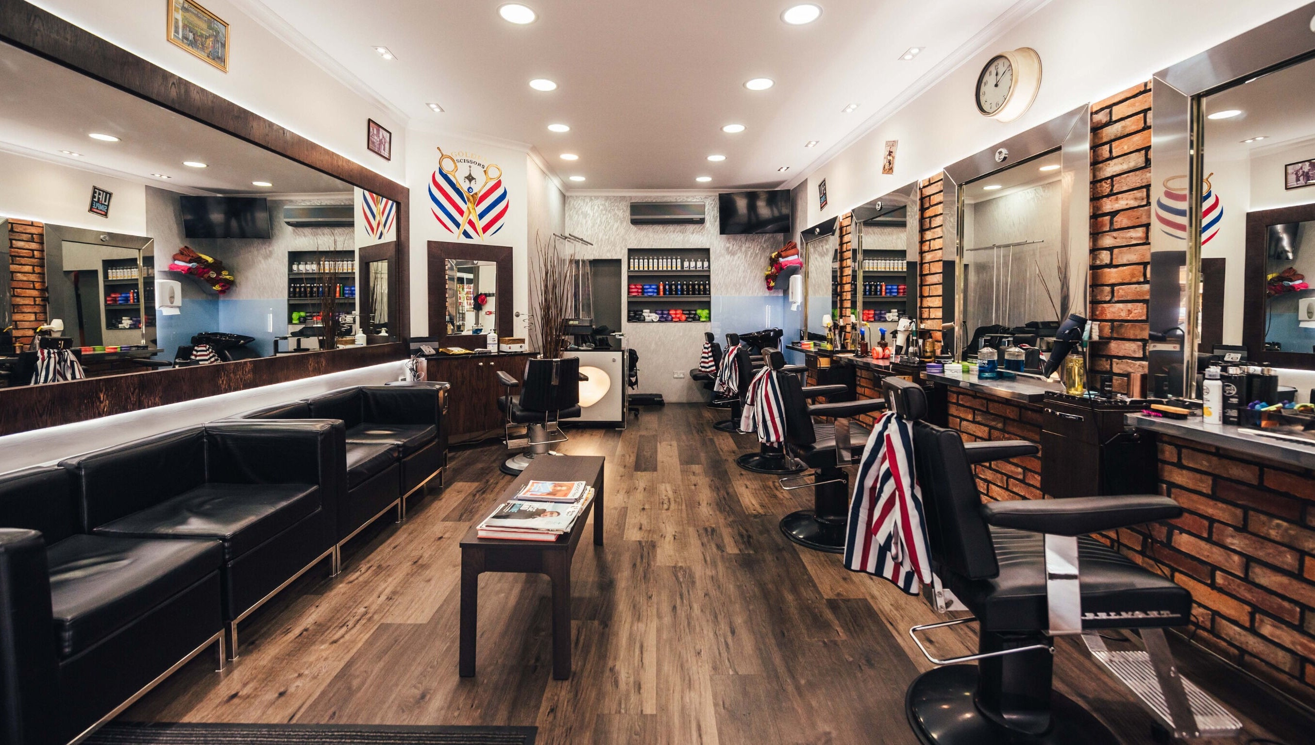 Modern interior of GOLDEN SCISSORS in London, England, GB, featuring sleek barber chairs and stylish decor.