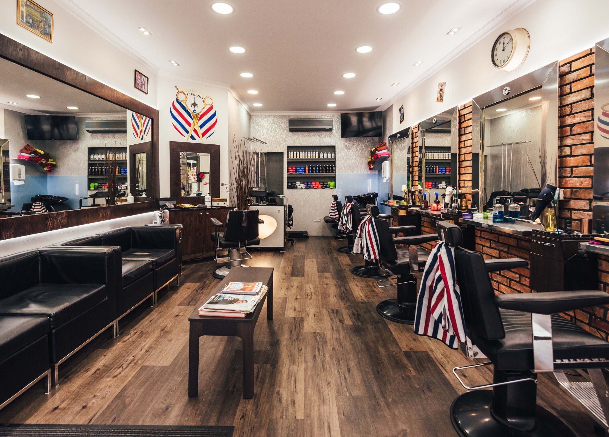 Modern interior of GOLDEN SCISSORS in London, England, GB, featuring sleek barber chairs and stylish decor.
