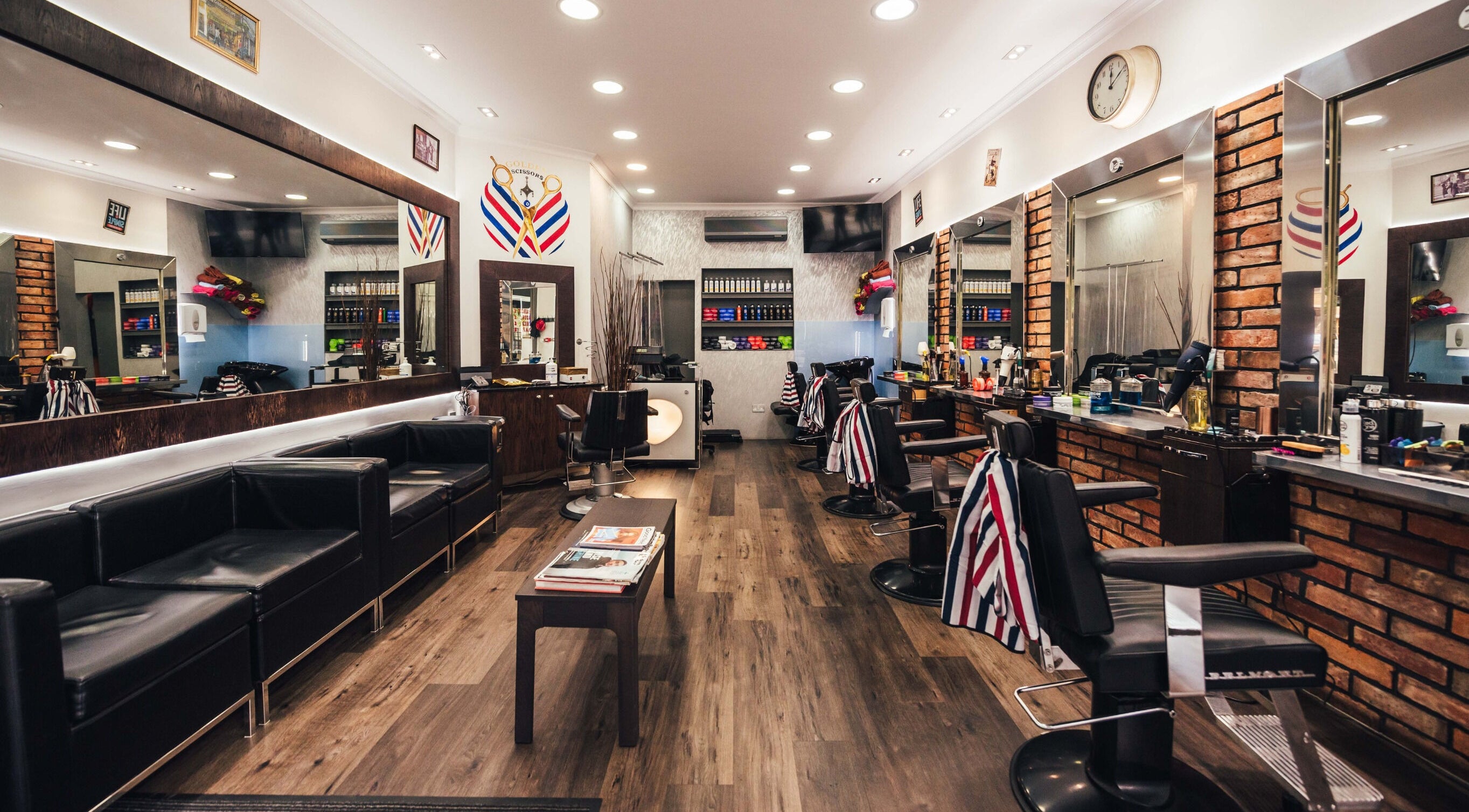 Modern interior of GOLDEN SCISSORS in London, England, GB, featuring sleek barber chairs and stylish decor.