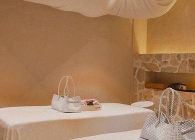 Peaceful massage room at Aetheria Natural Healing Spa, Canggu, Bali, ID with cozy lighting and stone decor.