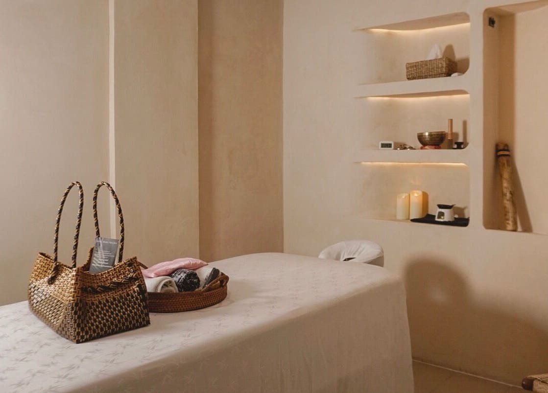 Serene massage room at Aetheria Natural Healing Spa, Canggu, Bali, ID with a massage table and calming decor.