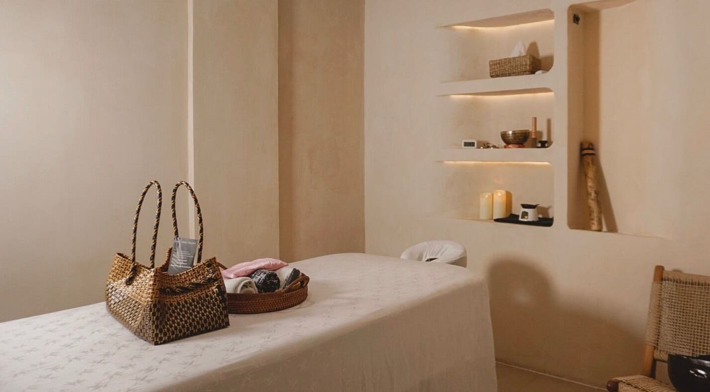 Serene massage room at Aetheria Natural Healing Spa, Canggu, Bali, ID with a massage table and calming decor.