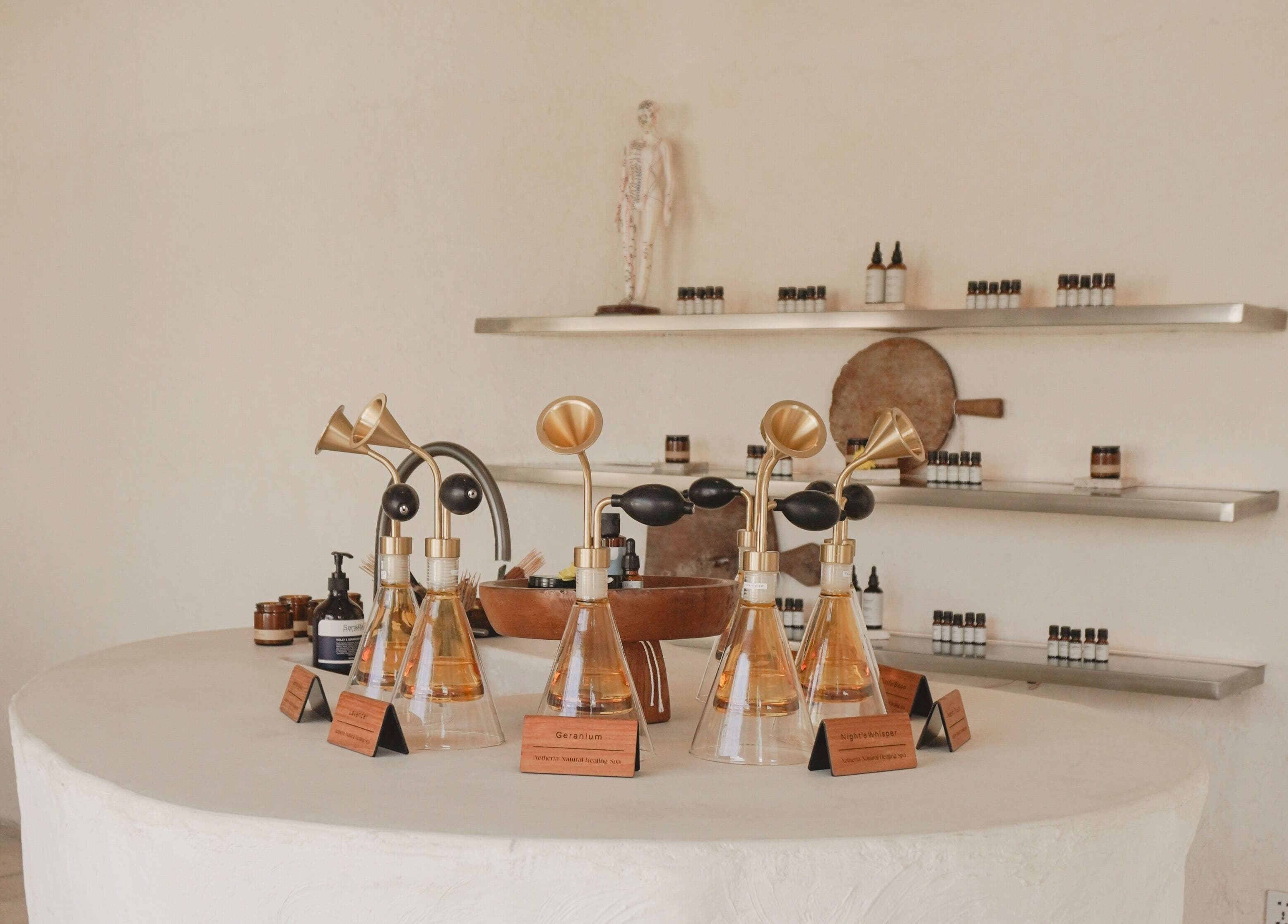 Aetheria Natural Healing Spa aromatherapy oils display in Canggu, Bali, ID, showcasing elegant wellness products.