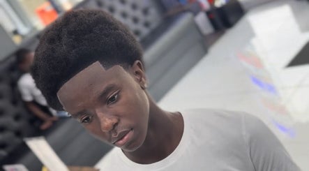 Young man with styled haircut at Abdul Universal Barber, Birmingham, England, GB.