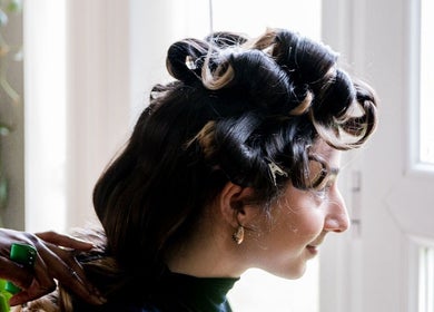 Woman getting her hair styled in elegant curls at Zulu Bonita, London, England, GB.