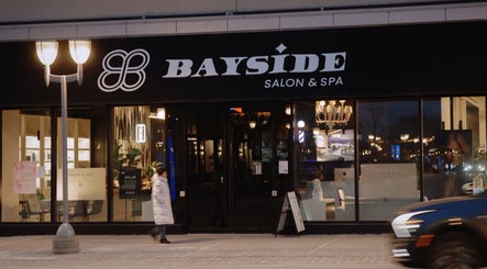 Front view of Bayside Salon and Spa in Toronto, Ontario, CA, beautifully illuminated at night.