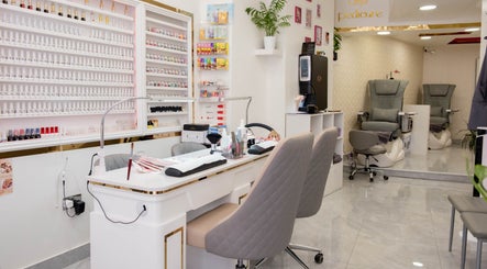 Elegant manicure setup at Kingscross Nails, London, England, GB with seating and nail polish display.
