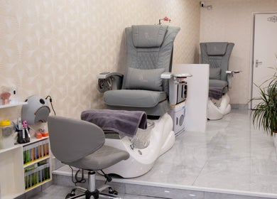 Elegant pedicure chairs at Kingscross Nails, London, England, GB. Modern spa setting enhancing relaxation.
