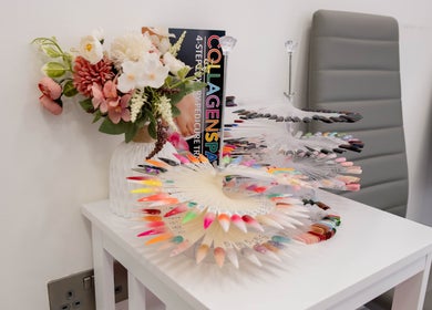 Colorful nail polish samples and flowers at Kingscross Nails, London, England, GB.