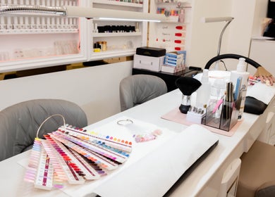 Modern nail salon station at Kingscross Nails, London, England, GB, showcasing a wide selection of polish colors.