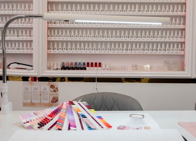 Colorful nail polish display at Kingscross Nails, London, England, GB, highlighting vibrant options.