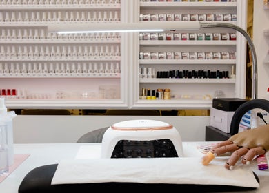 Manicure station at Kingscross Nails, London, England, GB showcasing tools and nail products.