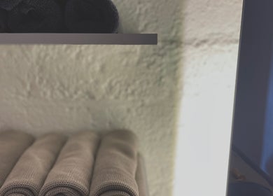 Rolled towels on a shelf at Sculptura: Anti-Cellulite & Body Sculpting, Bali, Bali, ID.