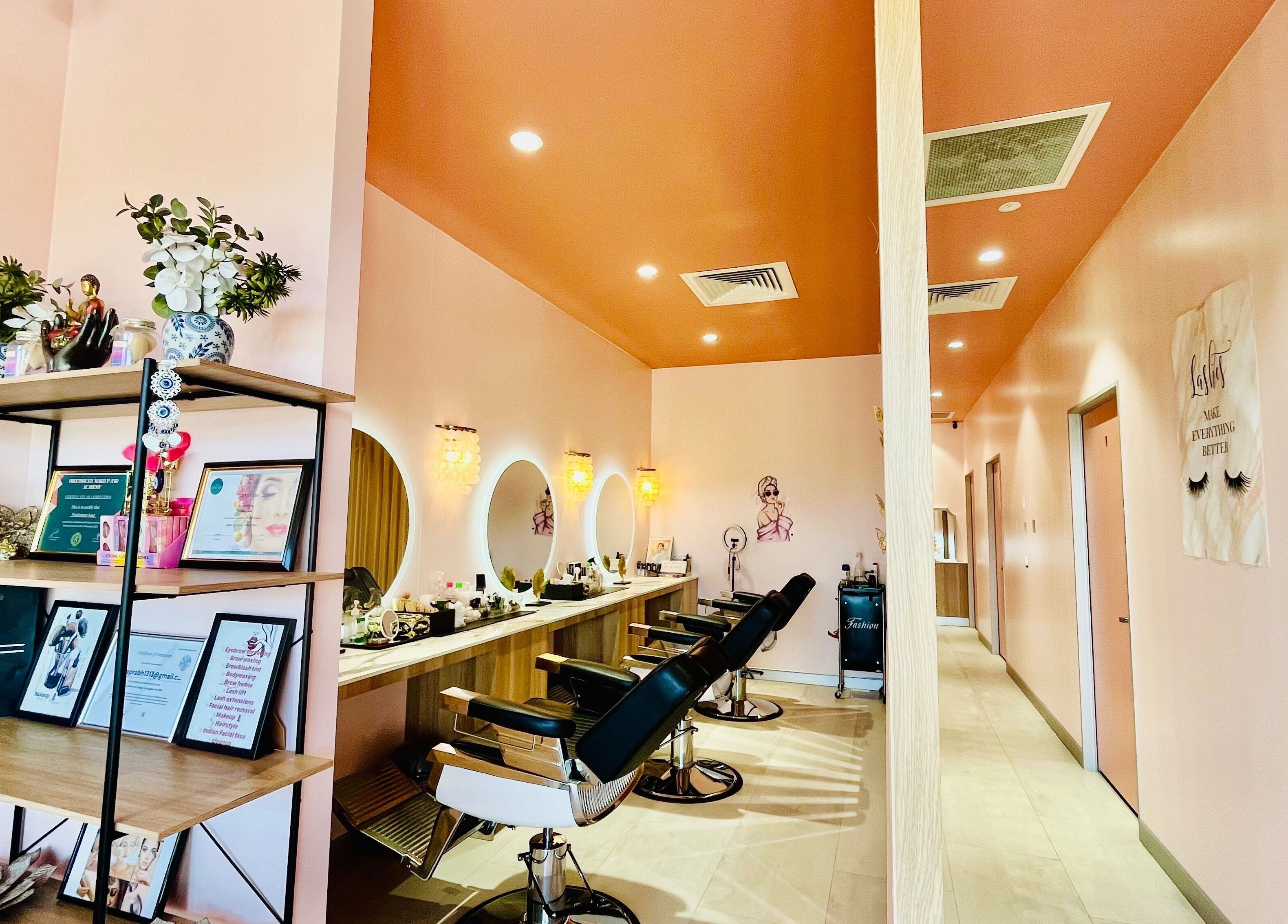 Modern salon interior at Sargis Beauty Stop, Greenbank, Queensland, AU featuring stylish chairs and mirrors.