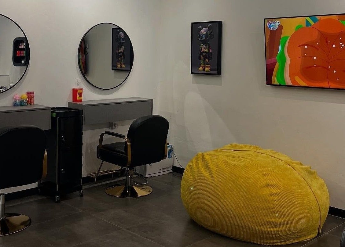Chic salon interior at Tots And Teens, Sandton, Gauteng, ZA with modern decor and vibrant yellow bean bag.