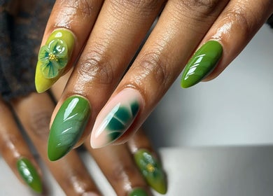 Green artistic nail design at Nailsby.Jona, Coventry, England, GB, showcasing intricate floral accents.