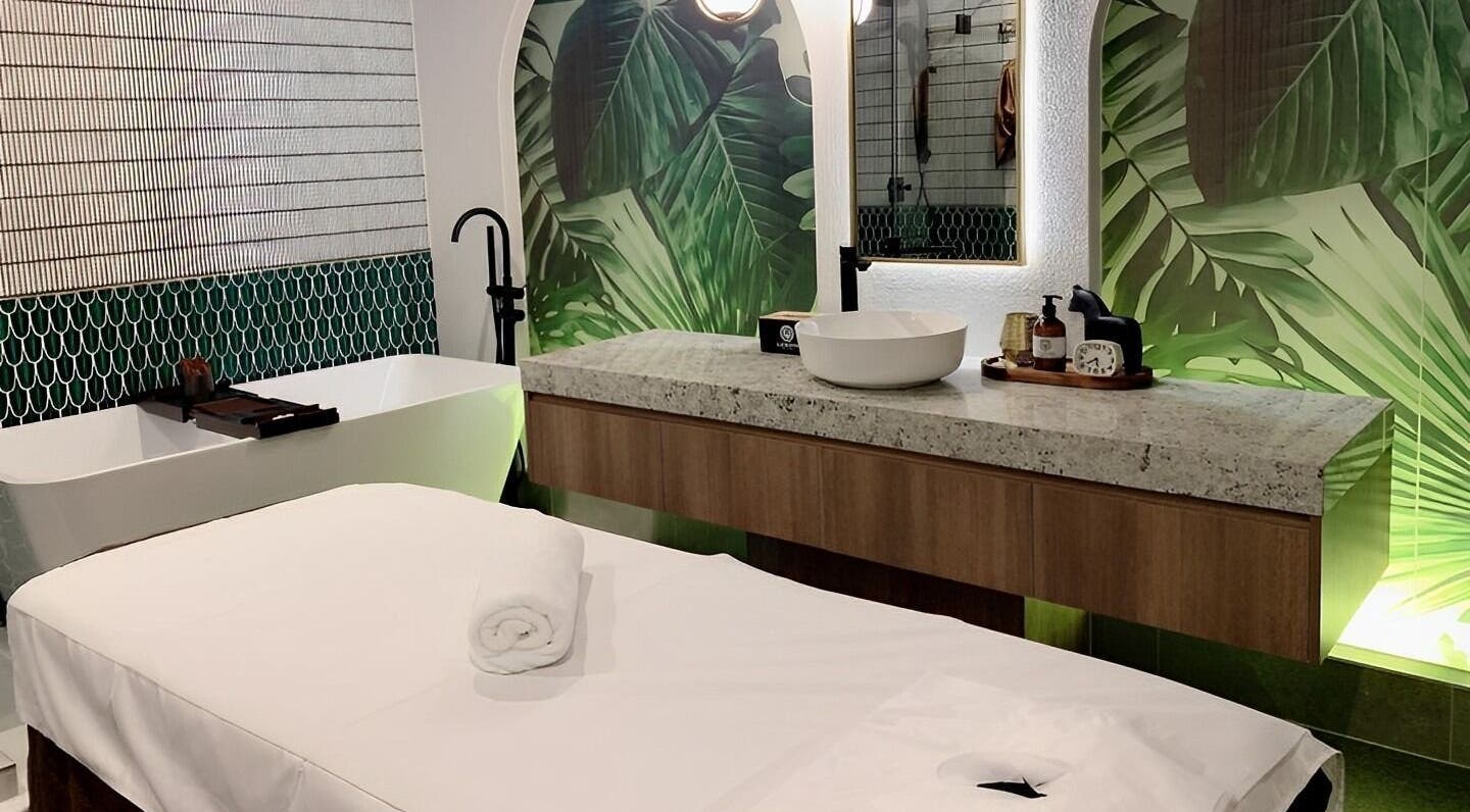 Relaxing treatment room at Lan Skin Clinic, Surfers Paradise, Queensland, AU, with lush green decor and spa amenities.