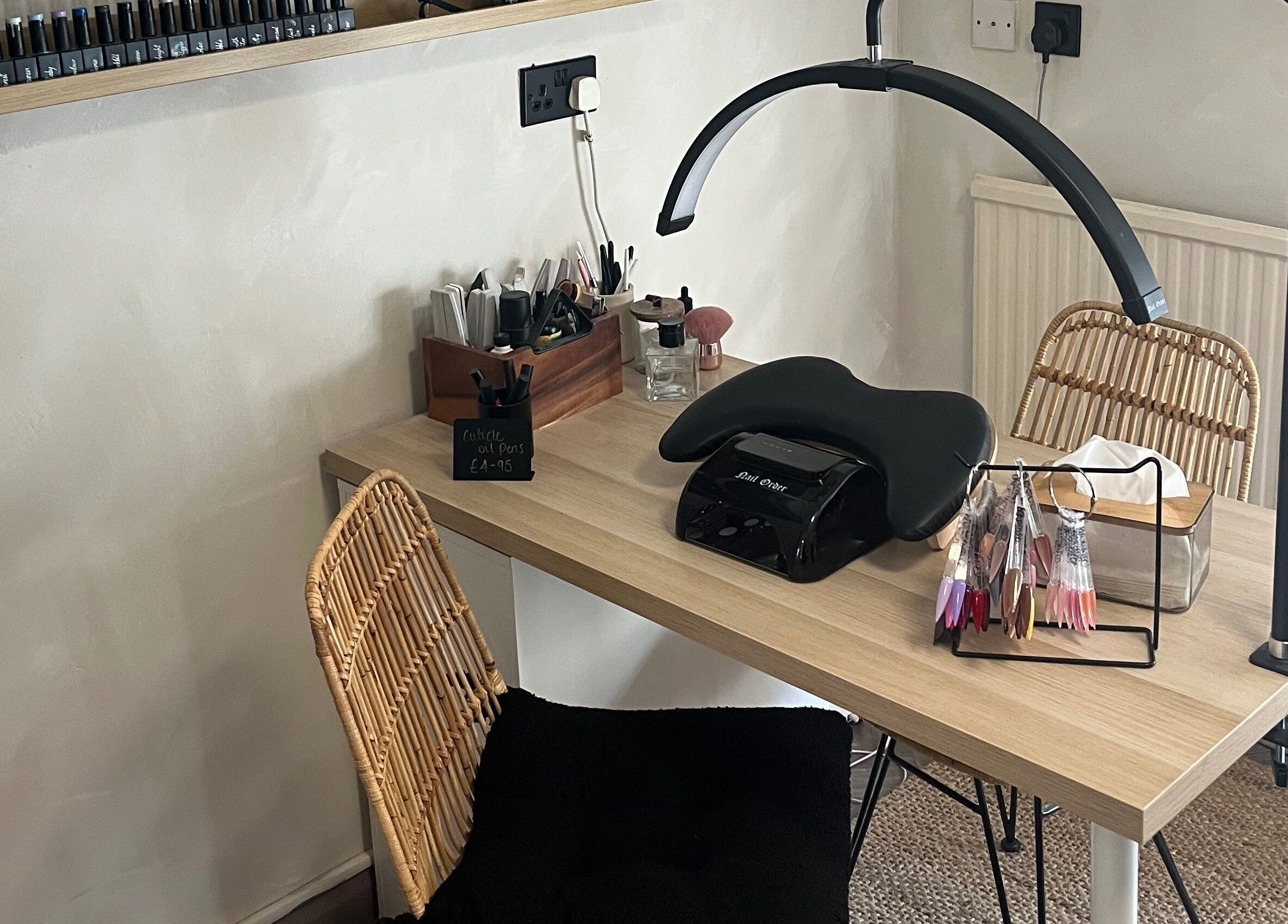 Nail care station at Jordon at Amica Hair & Beauty, Thirsk, England, GB with tools and a UV lamp.