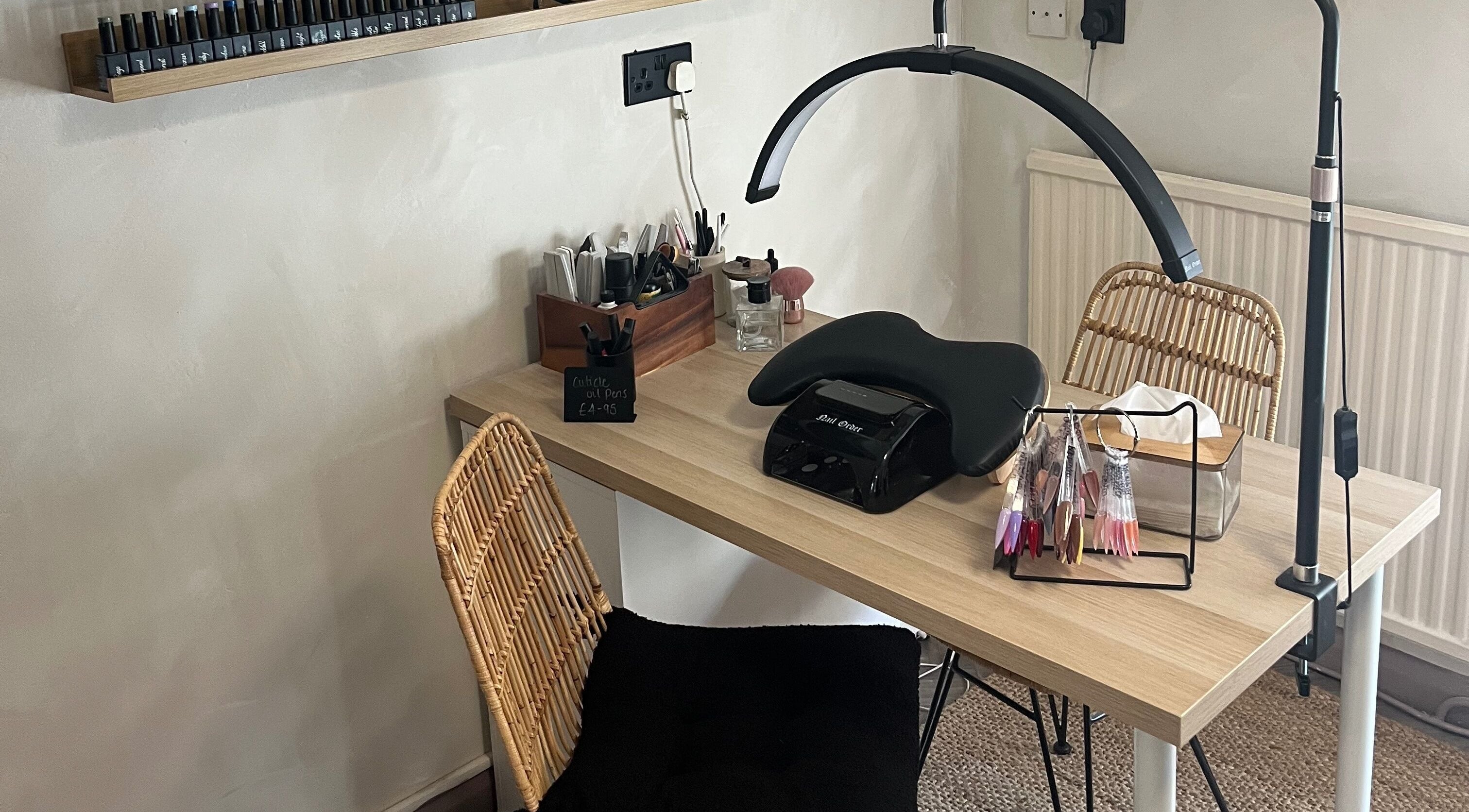 Nail care station at Jordon at Amica Hair & Beauty, Thirsk, England, GB with tools and a UV lamp.