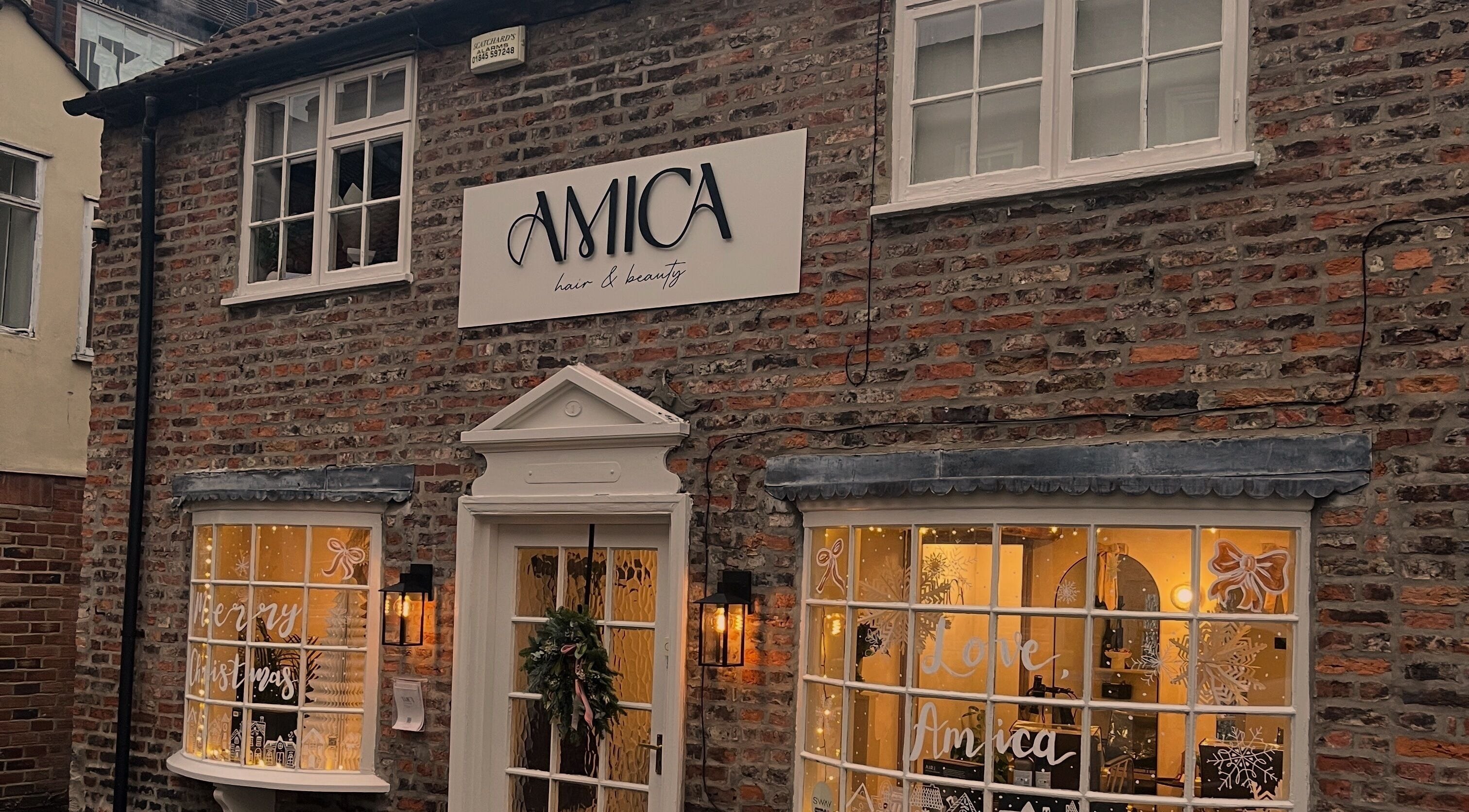 Jordon at Amica Hair & Beauty's inviting exterior in Thirsk, England, GB, decorated seasonally.