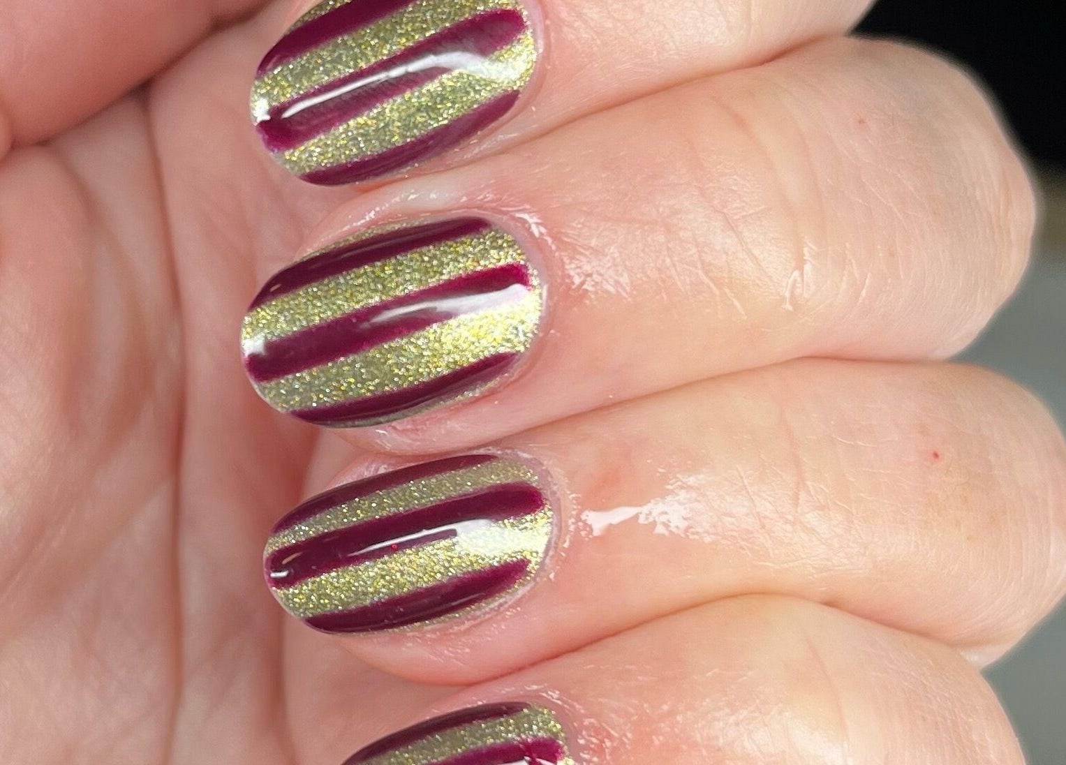 Elegant striped nails at Jordon at Amica Hair & Beauty, Thirsk, England, GB. Perfect nail art for any occasion.
