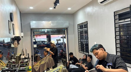 Stylish salon scene at TRYM, Tanjung Kling, Malacca, MY, featuring clients and hairstylists in a modern setting.