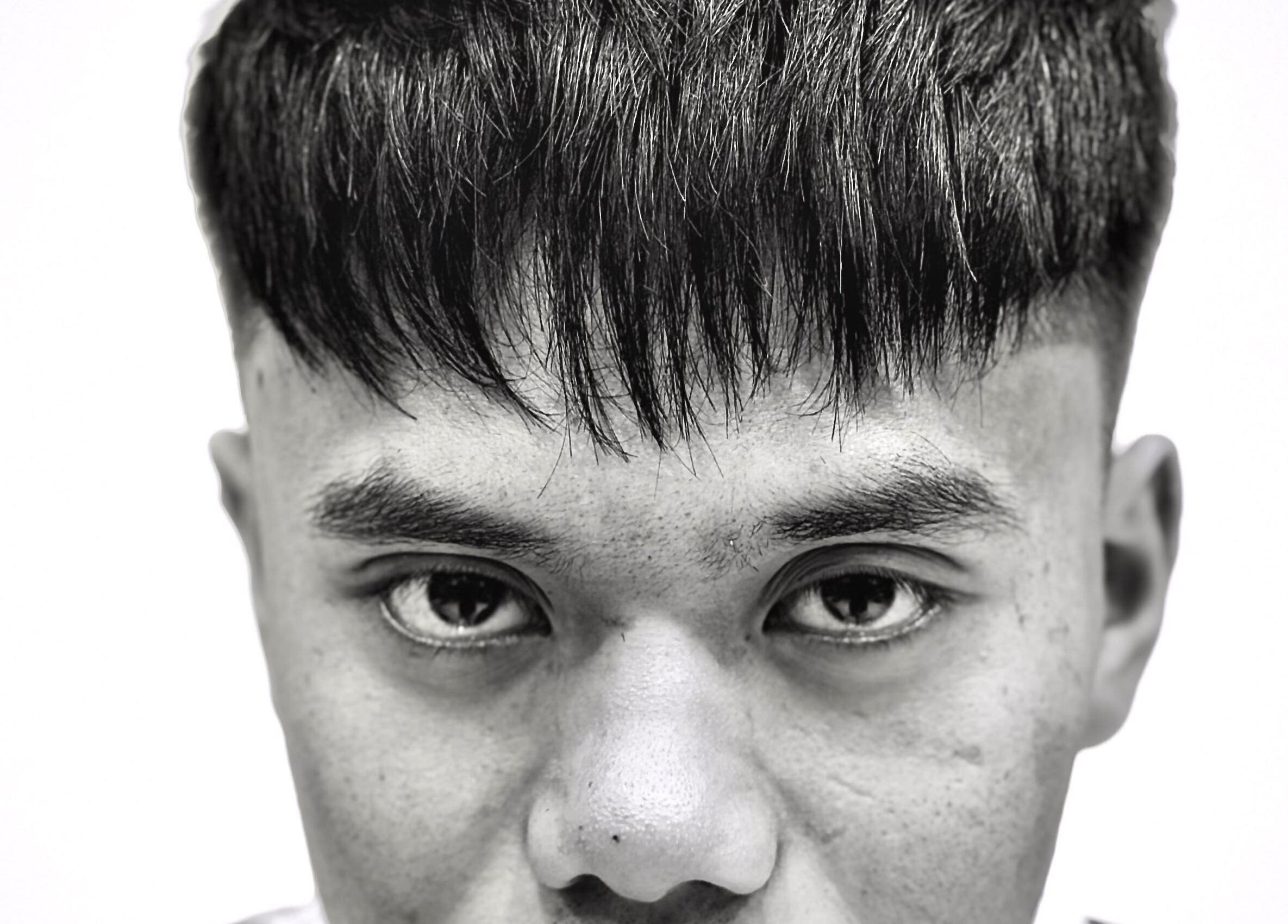 Close-up of trendy haircut at TRYM, Tanjung Kling, Malacca, MY, showcasing sharp fringes and sleek style.