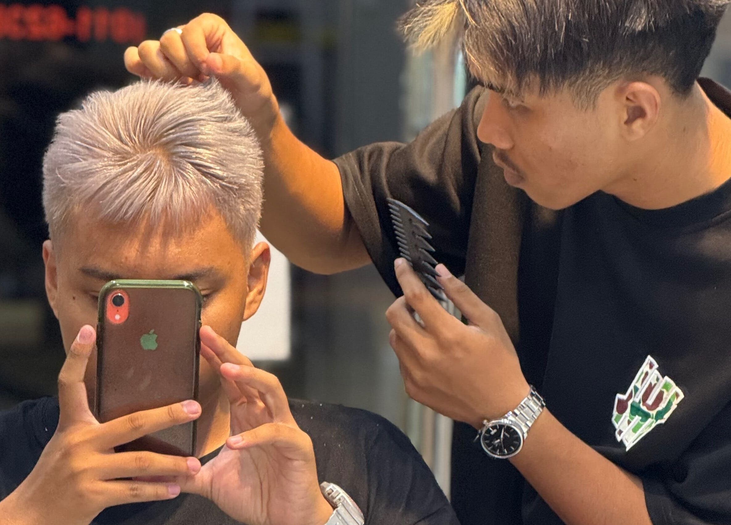 Hairstylist at TRYM Tanjung Kling, Malacca, MY perfecting a client's fresh silver hairstyle.