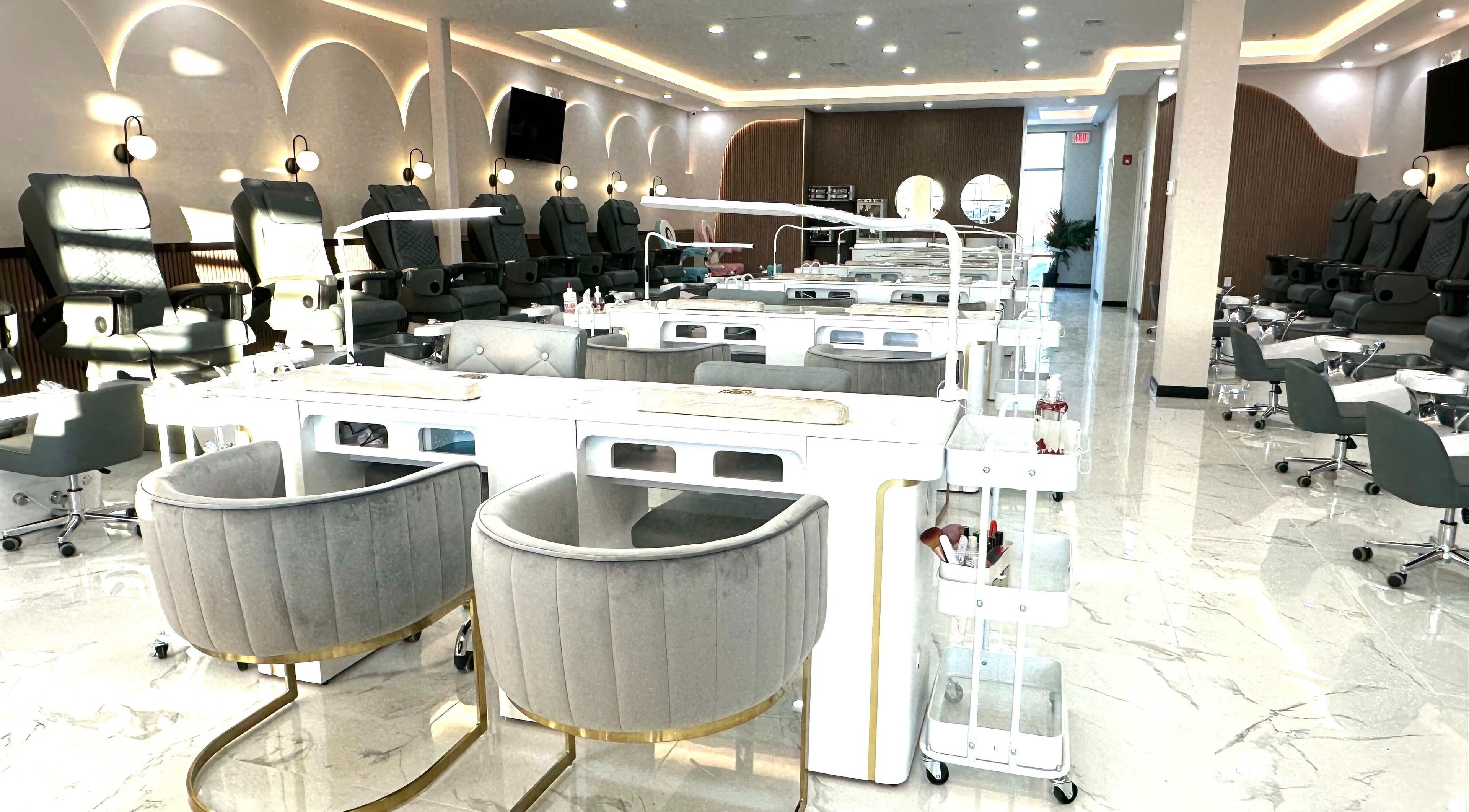 Interior view of Chi Nail Salon in Westfield, Indiana, US, featuring stylish manicure stations and chairs.