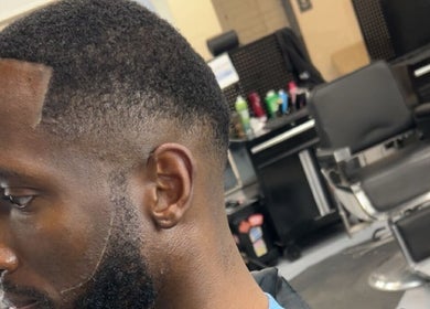 Close-up of a sharp faded haircut at FadedT0Glory in Kennewick, Washington, US. Styling chair in the background.