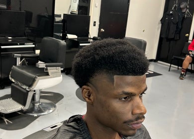 A stylish haircut at FadedT0Glory, Kennewick, Washington, US showcasing sleek black barber chair.