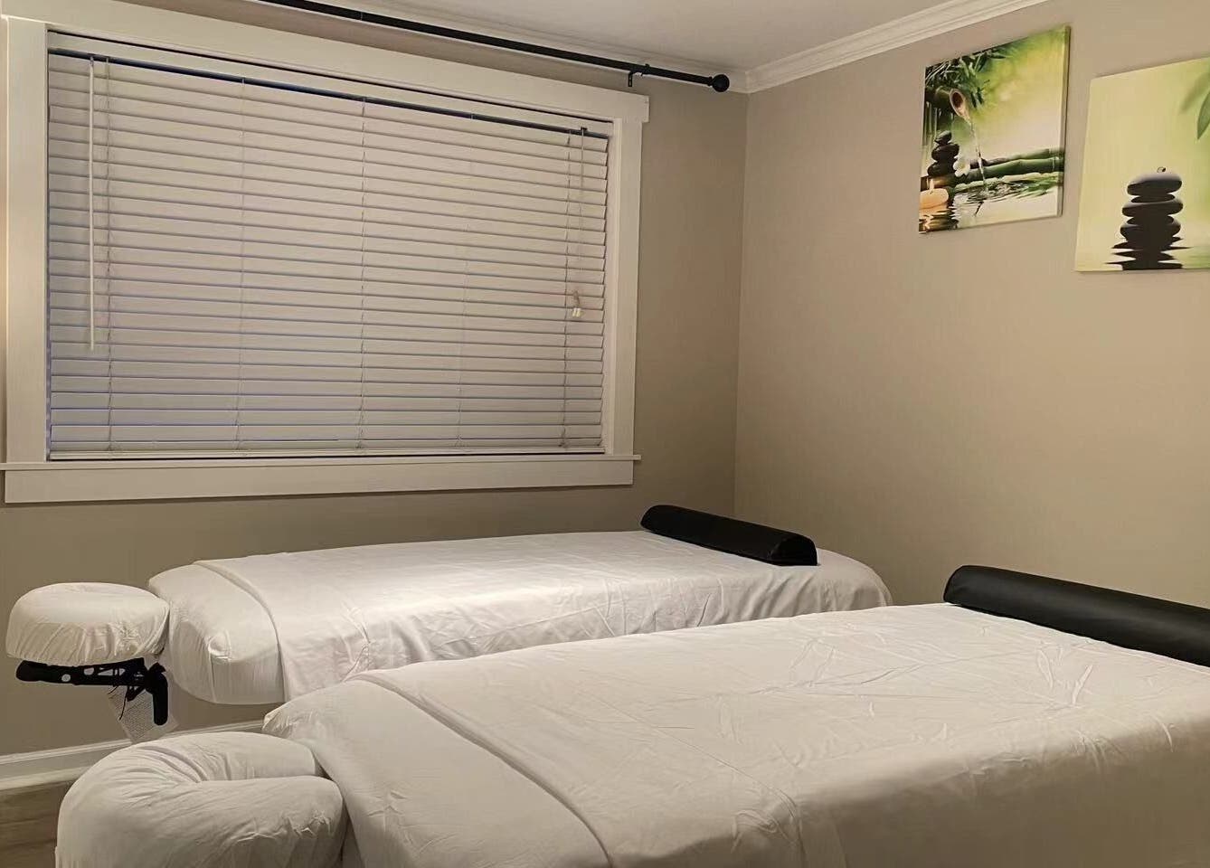 Tranquil massage room at S&C Wellness Spa, Everett, Washington, US, with two massage tables.