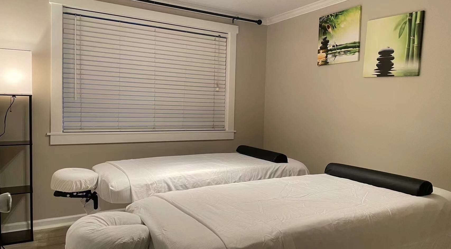 Tranquil massage room at S&C Wellness Spa, Everett, Washington, US, with two massage tables.