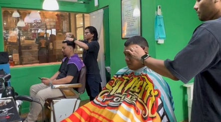 Barbers working at SNEAKYSNIPS BARBERSHOP in Johor Bahru, Johor Darul Ta'zim, MY. Stylish and vibrant interior.