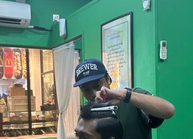 Barber styling hair at SNEAKYSNIPS BARBERSHOP, Johor Bahru, Johor Darul Ta'zim, MY.