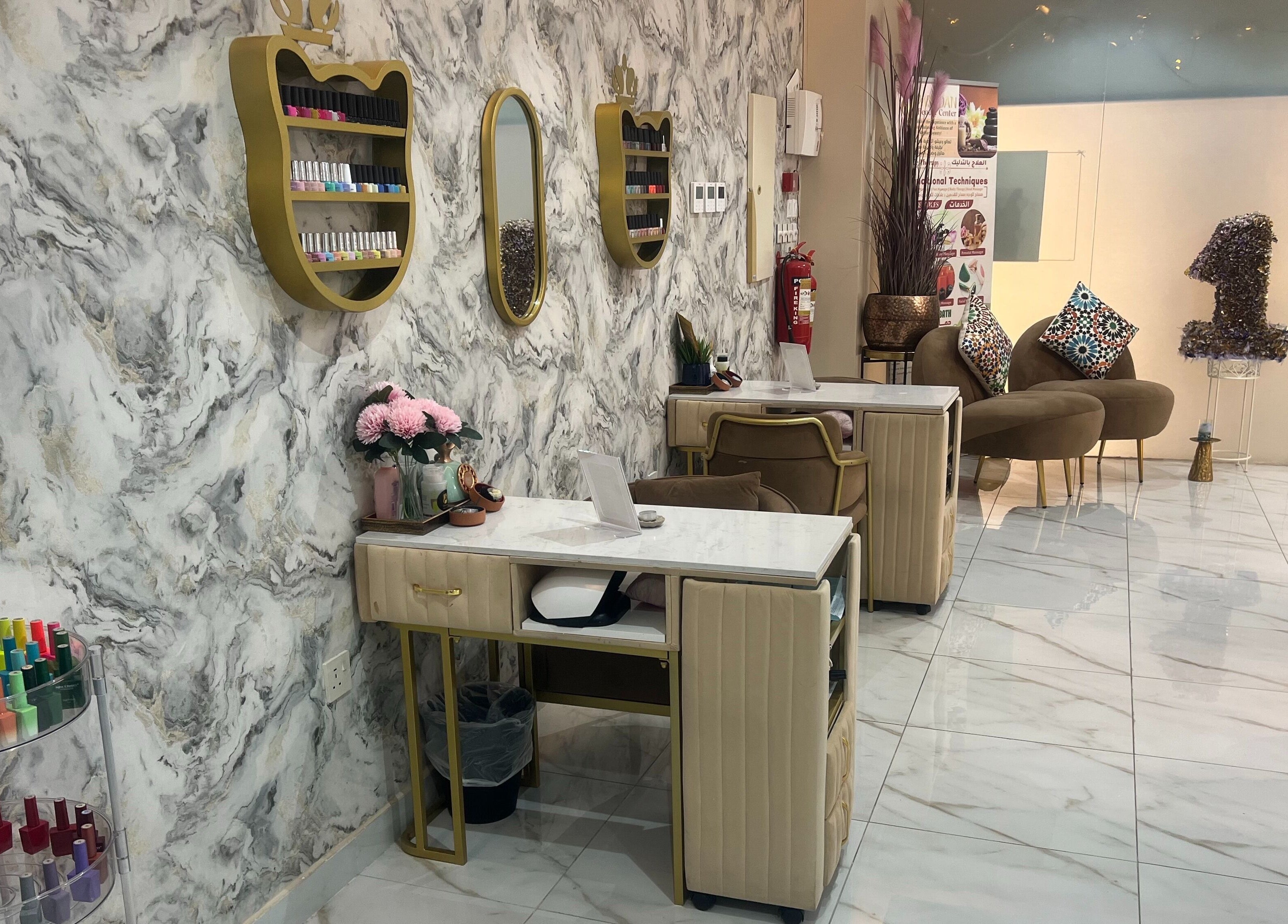 Nail station and seating area at Wejdan Aljamal Beauty Salon in Dhahran, Eastern Province, SA with marble decor.