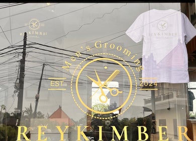 Rey Kimber Barbershop storefront with logo in Bali, Bali, ID, showcasing modern glass entrance.