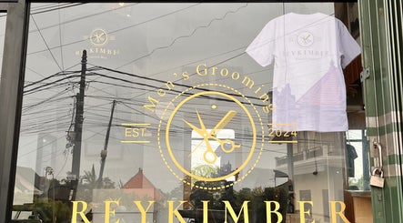 Rey Kimber Barbershop storefront with logo in Bali, Bali, ID, showcasing modern glass entrance.
